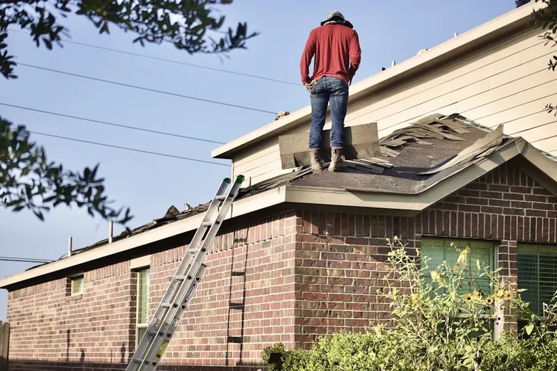 Professional roofer working on a residential roof in North Woodstock